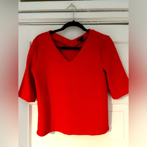 Red/coral structured T-shirt. Fabric has a 3-D small diamond/square pattern. - Picture 1 of 2